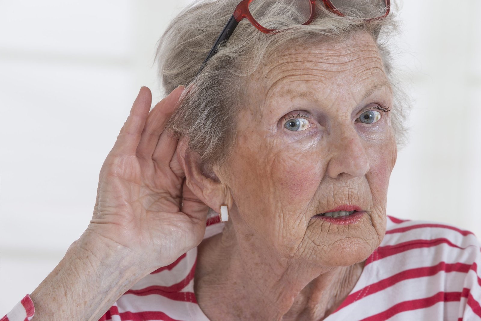 Mature woman holding hand to ear